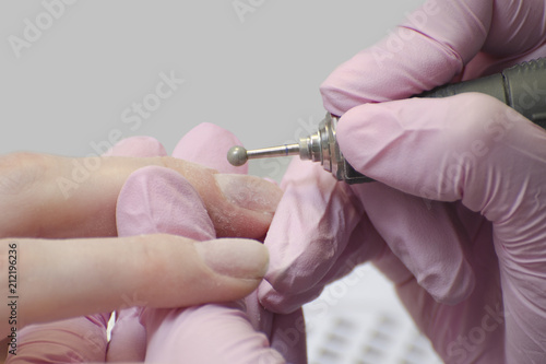 Nail treatment with a manicure cutter. Close up