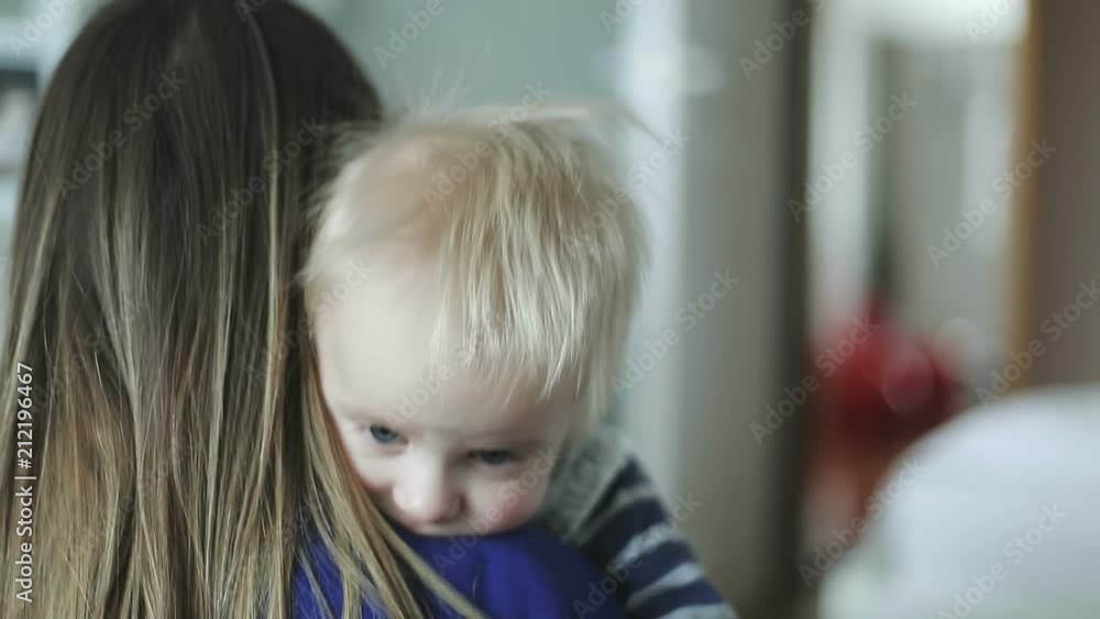 Daughter rushes into mother's and younger brother arms at home and gives her a big hug. Daughter rushes into mother's and younger brother arms at home and gives her a big hug.