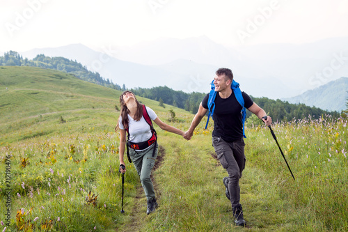 Young hipster couple hikes on mountain 