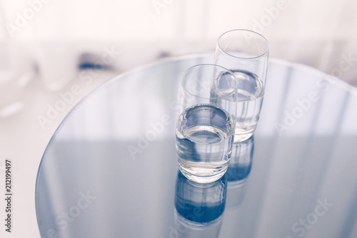 Two glasses of clean water on the glass table. Home.