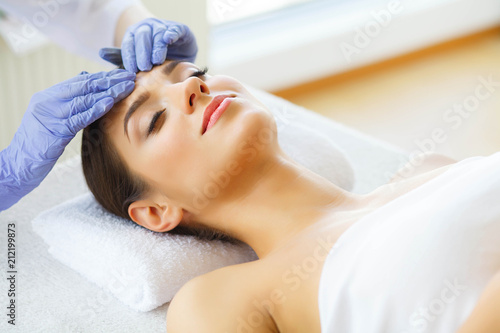 Skin Care Skin Procedures. Beautiful Young Woman in Spa Salon. Lying on Massage Tables and Relax. High Resolution photo