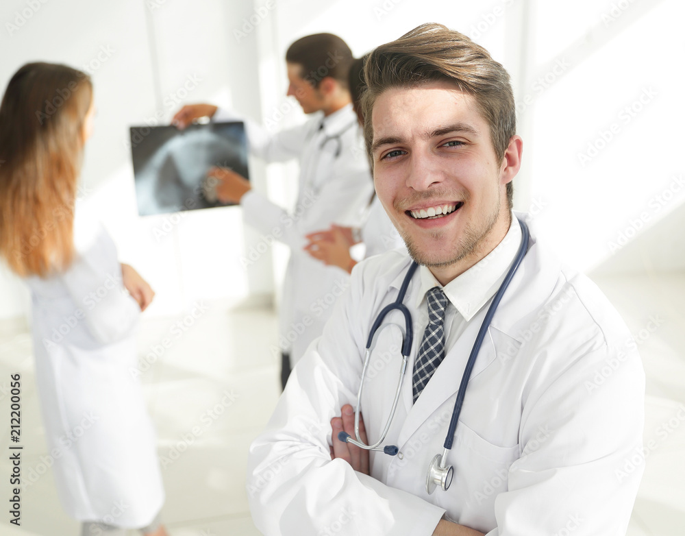 young doctor on the background of colleagues young doctor on the background of colleagues