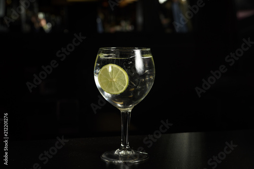 A glass of Gin Tonic cocktail drink with ice cubes  and a slice of lime ,Isolated .