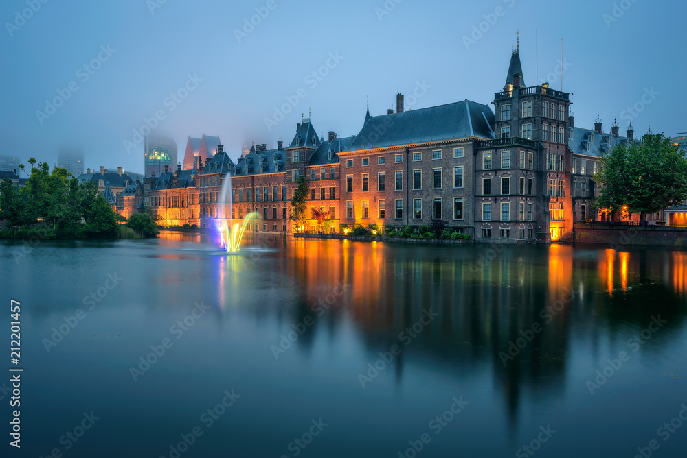 The Binnenhof palace in a foggy evening in Hague, Netherlands