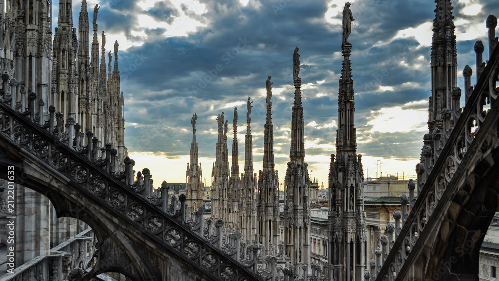 Roof terraces of gothic Milan Cathedral (Duomo) at sunset, Italy