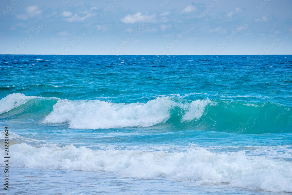 Fototapeta premium Sea view from tropical beach with sunny sky. Summer paradise beach of Bali island. Tropical shore. Tropical sea in Bali. Exotic summer beach with clouds on horizon. Ocean beach relax, Outdoor travel