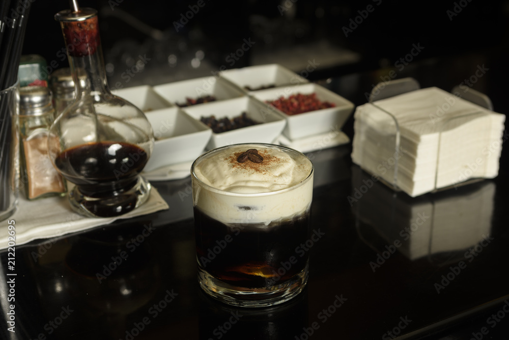 White Russian Cocktail with coffee beans and cinnamon garnished .