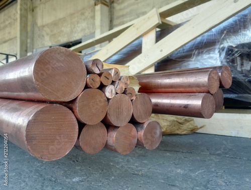 copper rods of round billets various diameters in warehouse photo