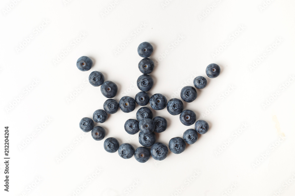 Eye with three eyelashes of blueberries on white background