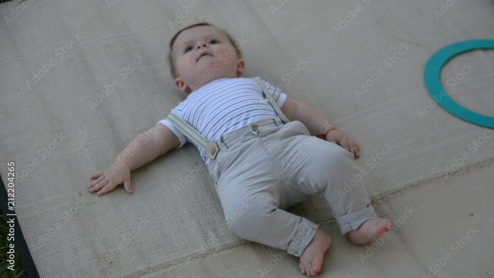 Cute baby lying on the pillow in the park
