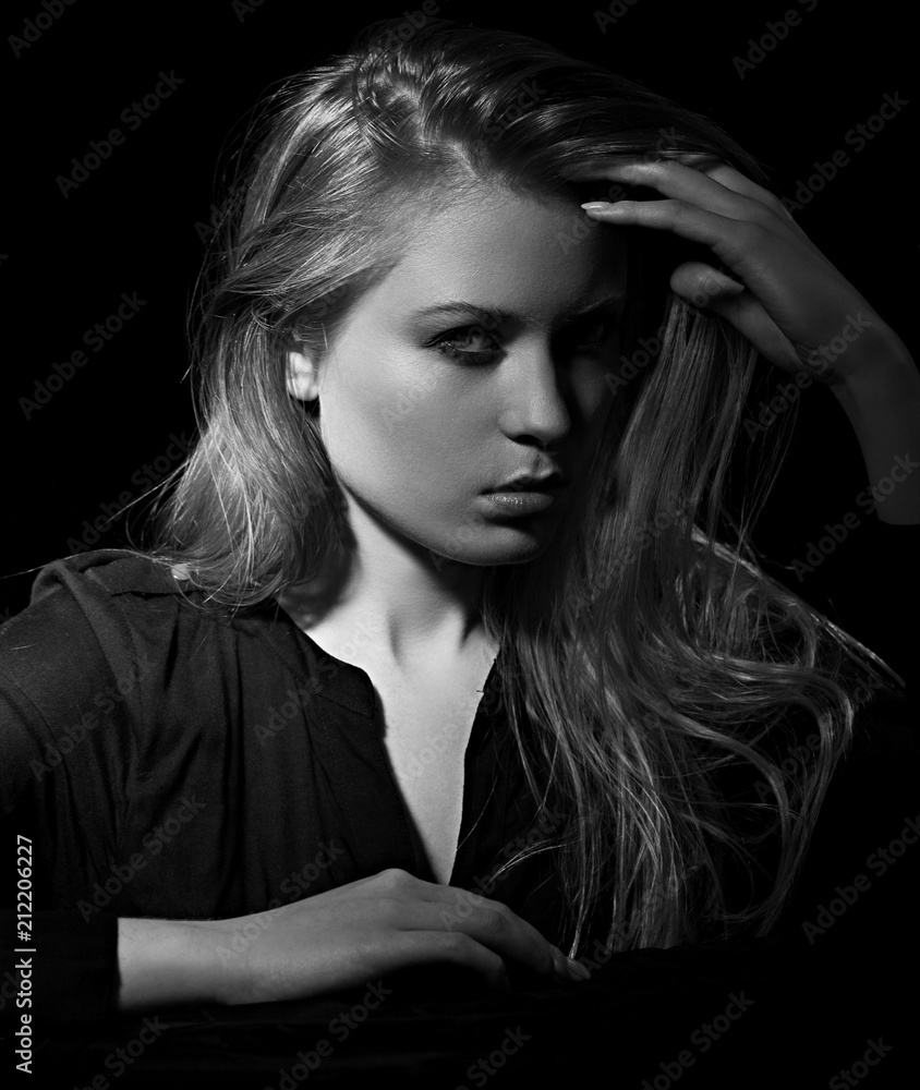 Sexy haughty glamour female model with long blond hair posing in black ...