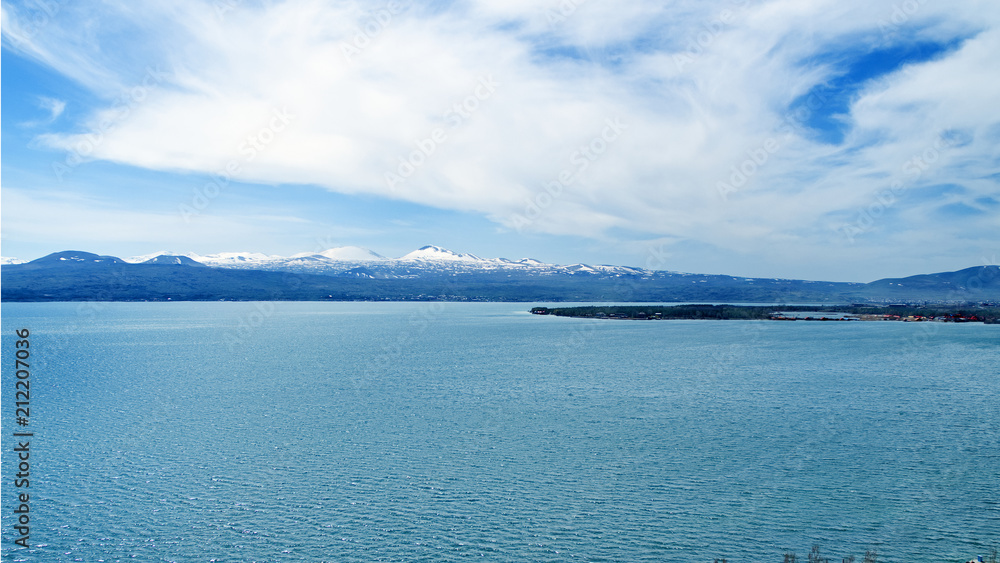 Lake Sevan in Armenia, beautiful view of lake on a sunny bright spring day, beautiful clouds Lake Sevan in Armenia, beautiful view of lake on a sunny bright spring day, beautiful clouds