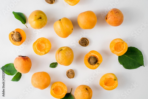 Many apricots on the white background. Top view