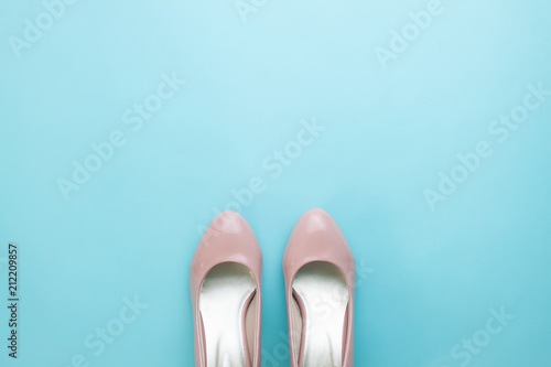 Pair of pastel pink woman's shoes on turquoise color background, Fashion minimal concept photo