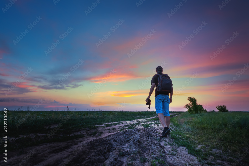man on a wheat field / photographer in search of spring sunset plot