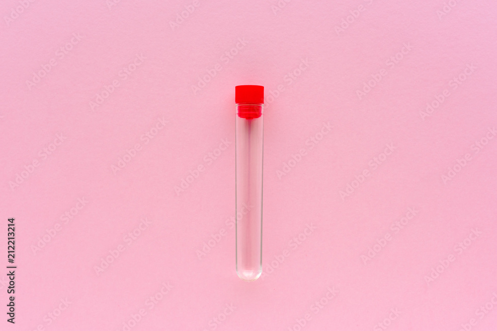 Empty specimen tube on pink background Empty specimen tube on pink background