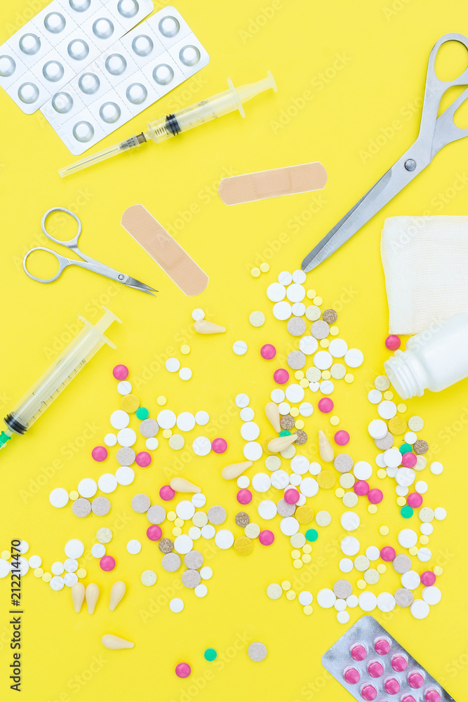 pills on a yellow background pills on a yellow background