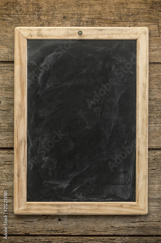 Blank chalkboard on rustic wooden background