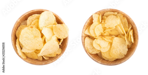 Potato chips in wooden bowl on a white background, top view.