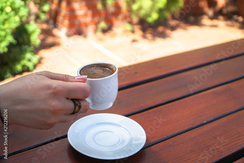 Bild auf Leinwand A Woman Holding a Cup of Turkish Coffee