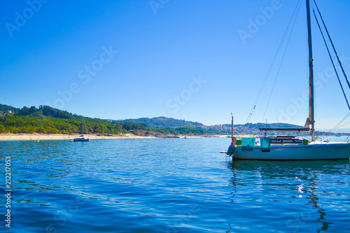 Boat diving in front of a beach of Cies Islands, in Galicia, Spain