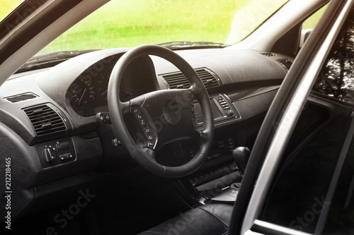 View of the interior of a modern automobile showing the dashboard. Black leather car interior