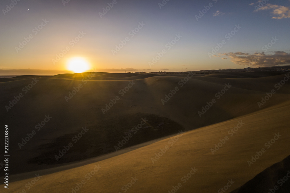 dunes in desert are sandy and are all the time in the move, wind is blowing the sand and making new hills, shapes and creations