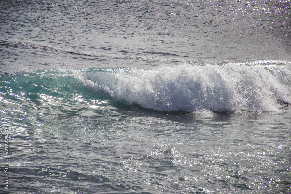 typical windy day in gran canaria, canary islands, spain. ideal for surfing, bigger waves in the sea, turquoise blue water in the ocean typical windy day in gran canaria, canary islands, spain. ideal for surfing, bigger waves in the sea, turquoise blue water in the ocean