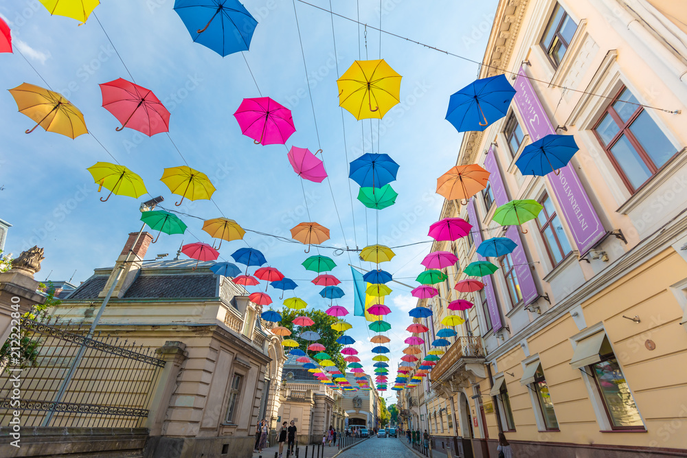 Colorful umbrellas hanging on the street in Lviv