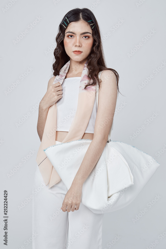 Beautiful happy woman holding a bag in studio. Beautiful happy woman holding a bag in studio.