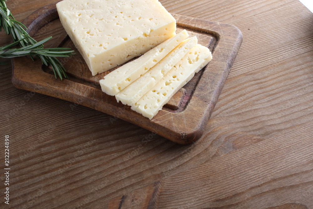 cheese cut on a wooden background