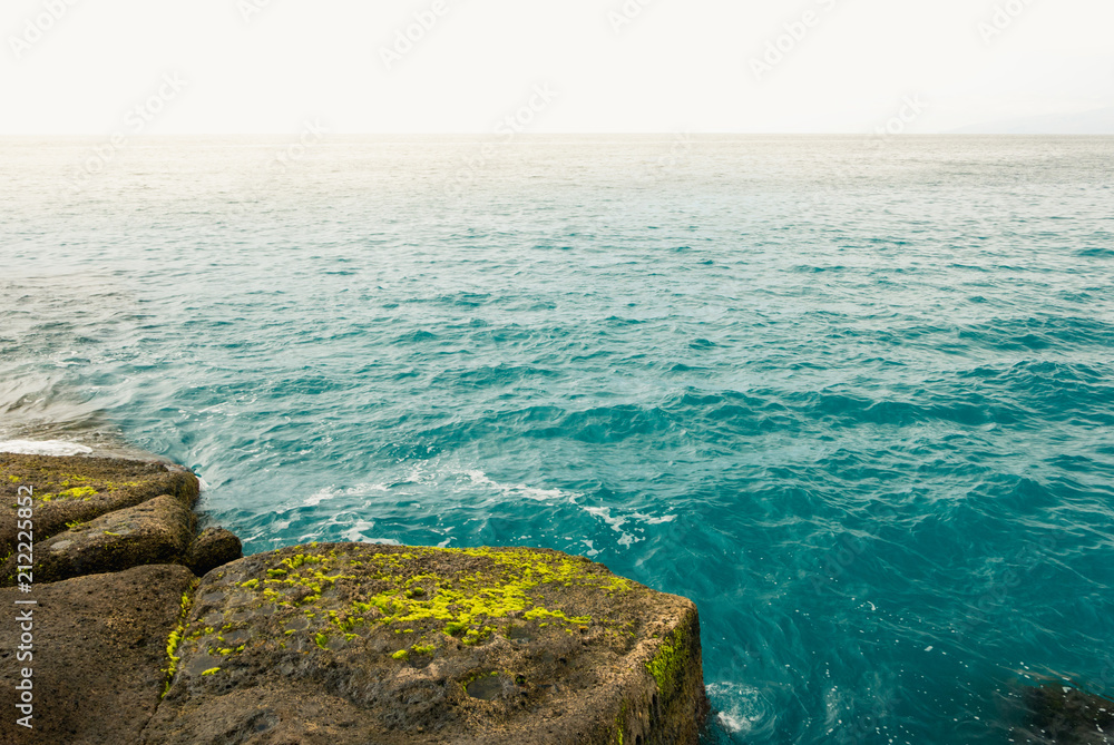 Beautiful sea water and rocky coast of tropical El Duque beach.