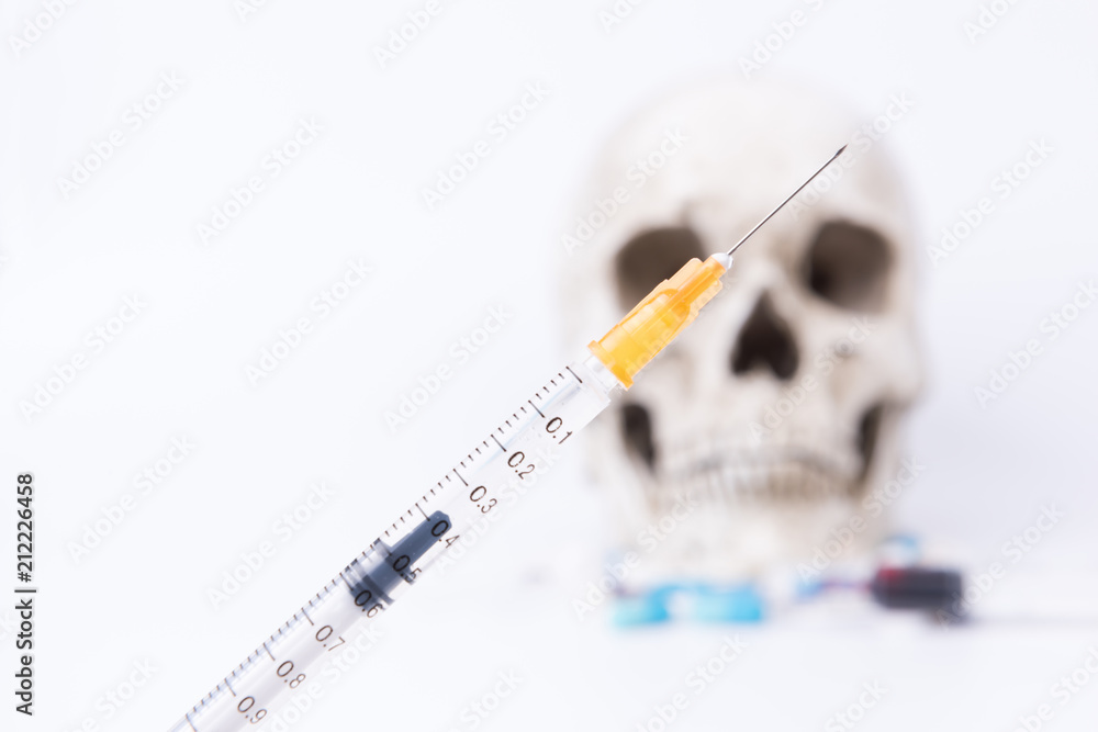 Skull and syringe on white background. Drug abuse, deadly dose of death. Skull and syringe on white background. Drug abuse, deadly dose of death.