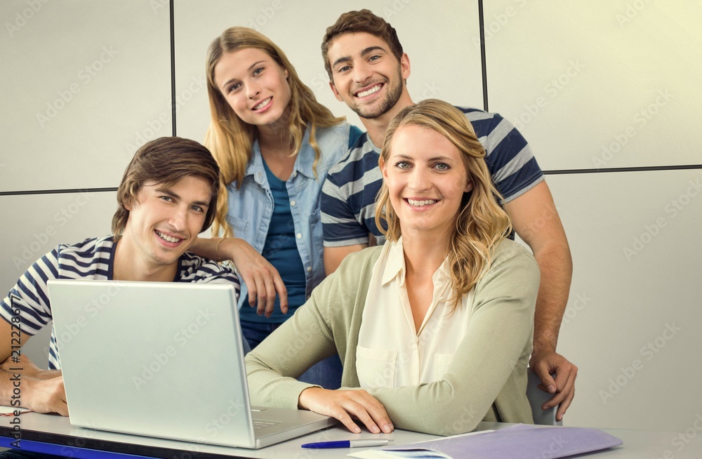 Composite image of students using laptop in classroom Composite image of students using laptop in classroom