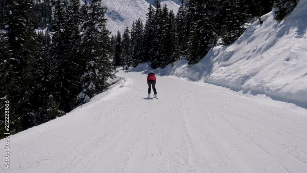 Skier Bend Down To Quickly Skiing Down On The Mountainside In Winter Skier Bend Down To Quickly Skiing Down On The Mountainside In Winter