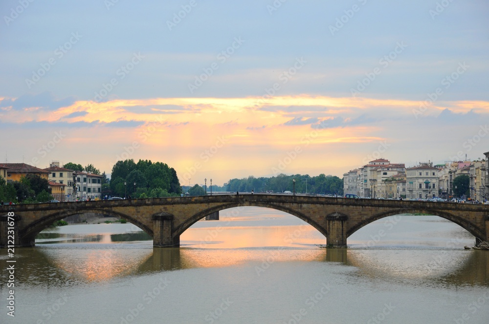 Ponte Alla Carraia Bridge at sunset on the Arno River, in Florence, Italy