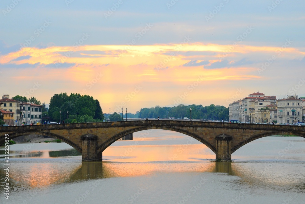 Ponte Alla Carraia Bridge at sunset on the Arno River, in Florence, Italy