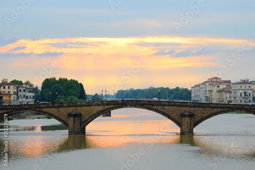 Ponte Alla Carraia Bridge at sunset on the Arno River, in Florence, Italy photo