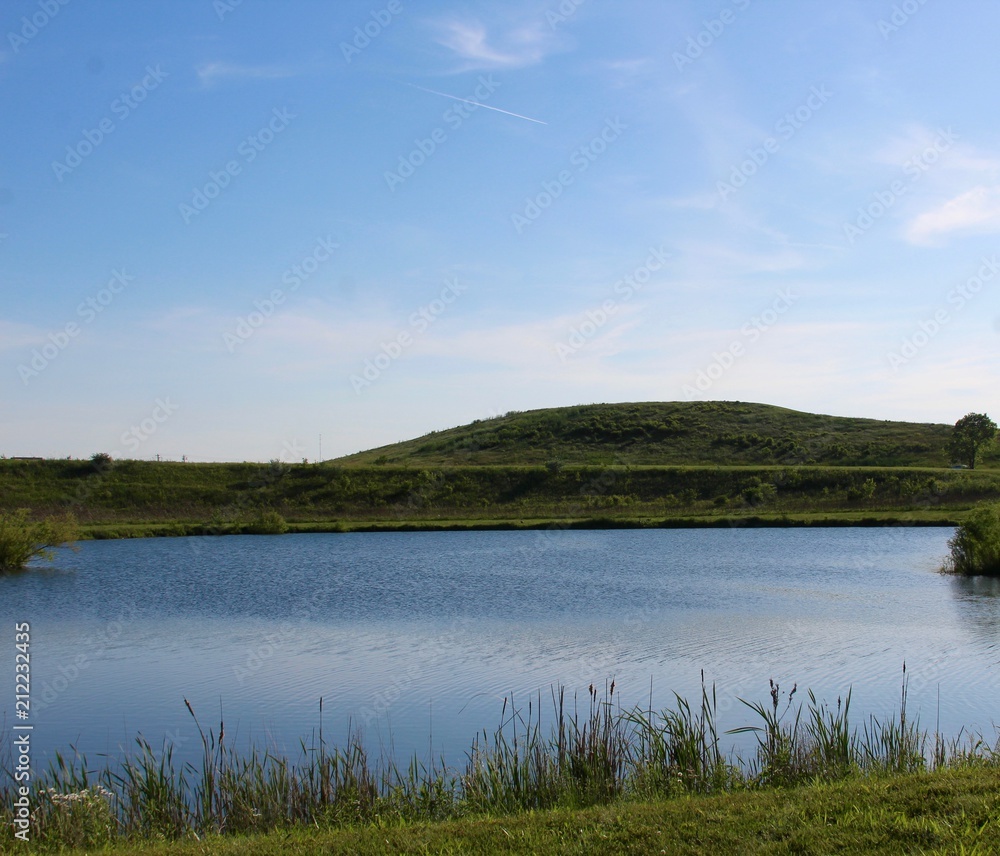 A view of the lake and the hill in the evening sky.