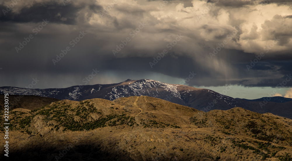 Dramatic rain storm cloud form over the snow mountain in New Zealand
