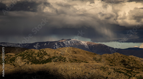 Dramatic rain storm cloud form over the snow mountain in New Zealand