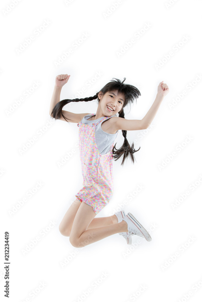 Portrait of Happy Asian child girl jumping and smiling isolated on white background