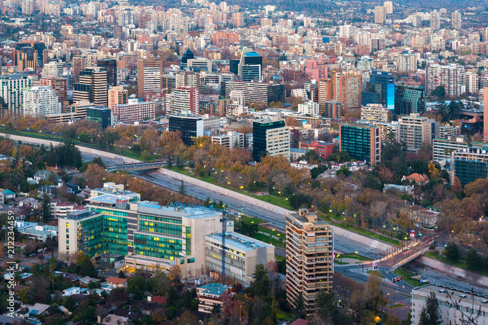 Naklejka premium Santiago, Metropolitan Region, Chile - June 01, 2013: Panoramic view of Providencia district with Mapocho River and the snowed Andes mountain range in the back.