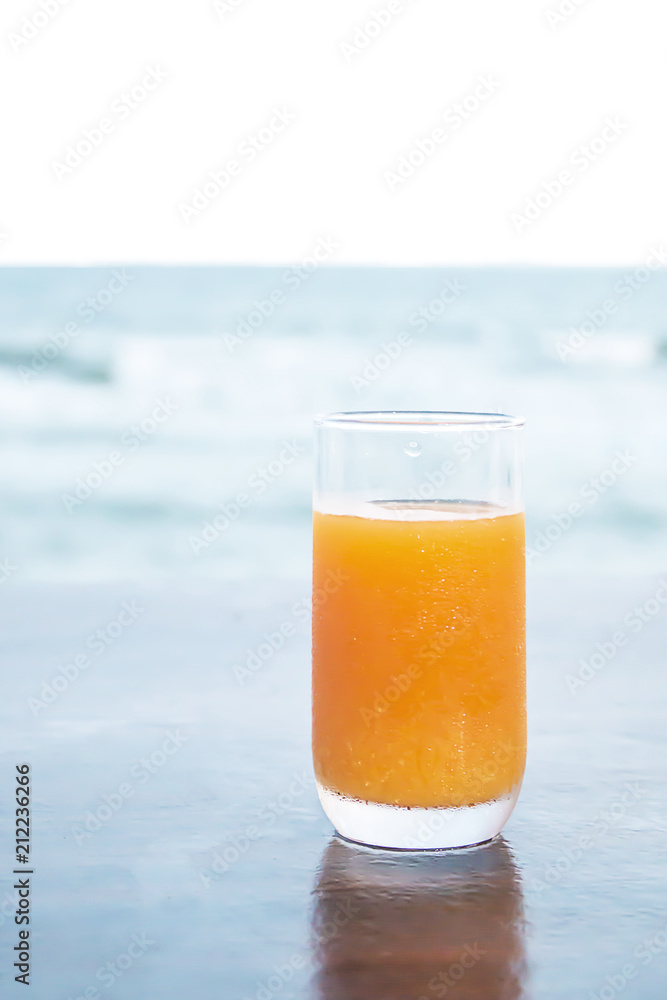 Orange juice on table by the sea. Orange juice on table by the sea.