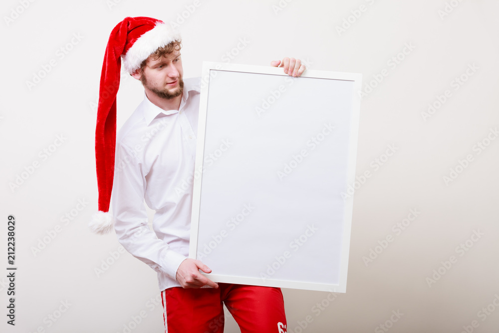 Man in santa hat with blank banner. Copy space. Man in santa hat with blank banner. Copy space.