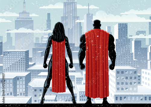 Superhero couple watching over the city in the snow.