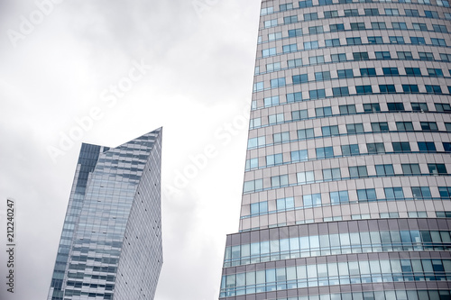   view of skyscraper windows  old city in the reflection of a new building   mixture of glass  metal and concrete 