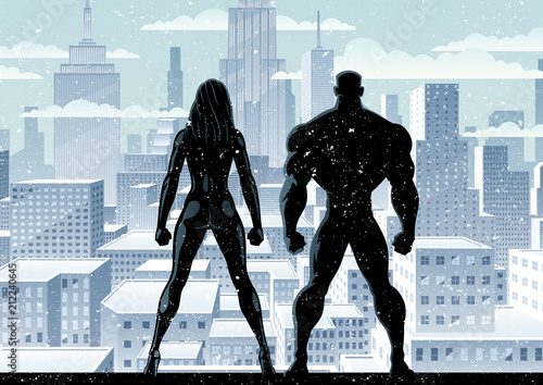 Superhero couple watching over the city in the snow.