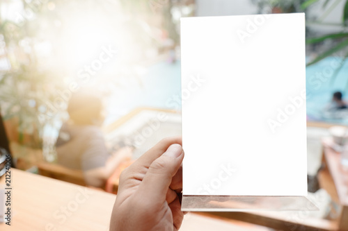 hand hold blank square paper over blur background