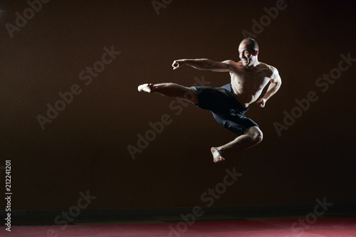 Adult man athlete beats a kick in a jump © andreyfire